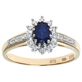 0.52ct Oval Sapphire and 0.1ct Round Diamond Cluster Ring with Side Stones in UK Hallmarked 9ct Yellow Gold